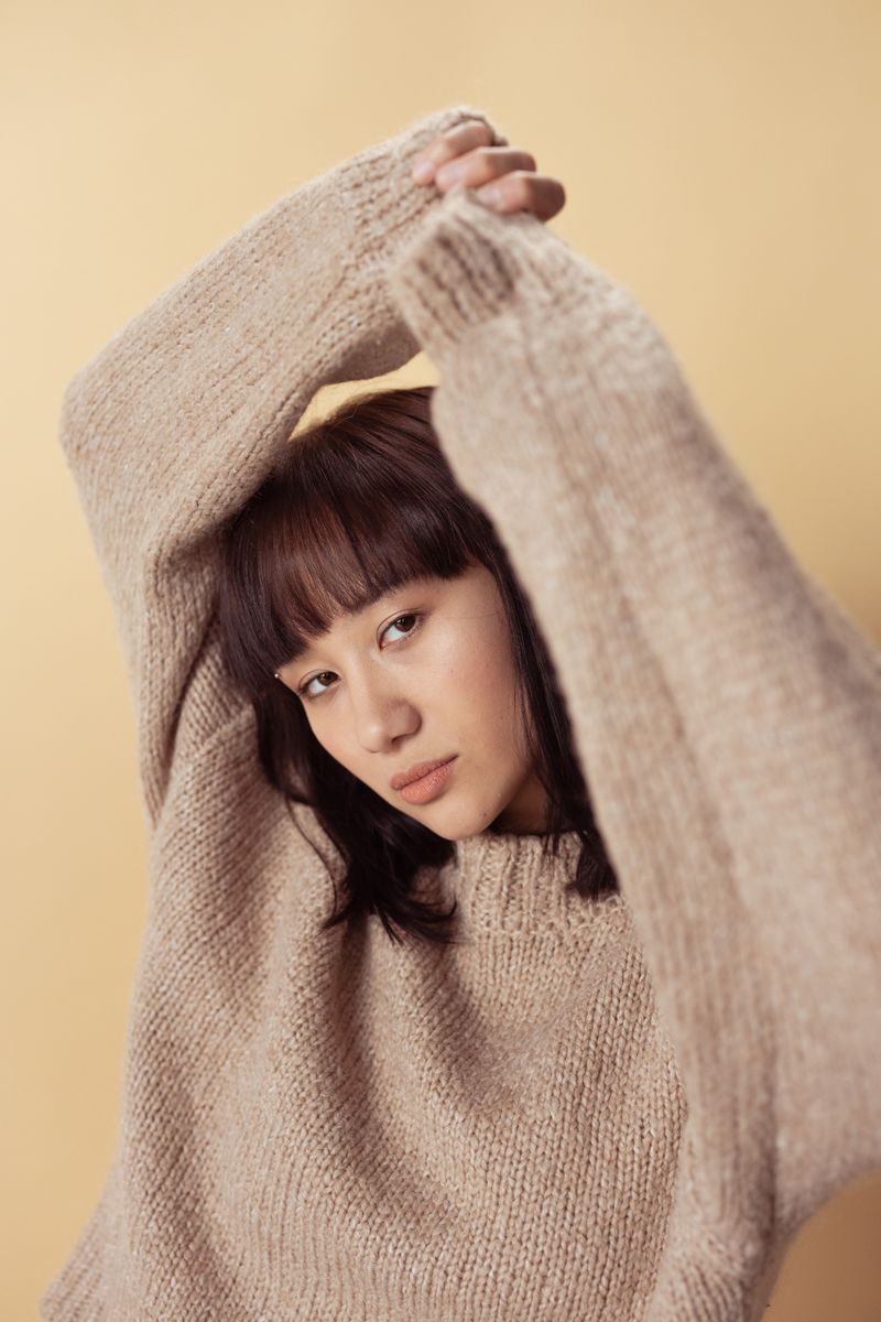 Woman wearing an elegant beige knit sweater