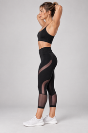 Black mesh-panel capri leggings — side view